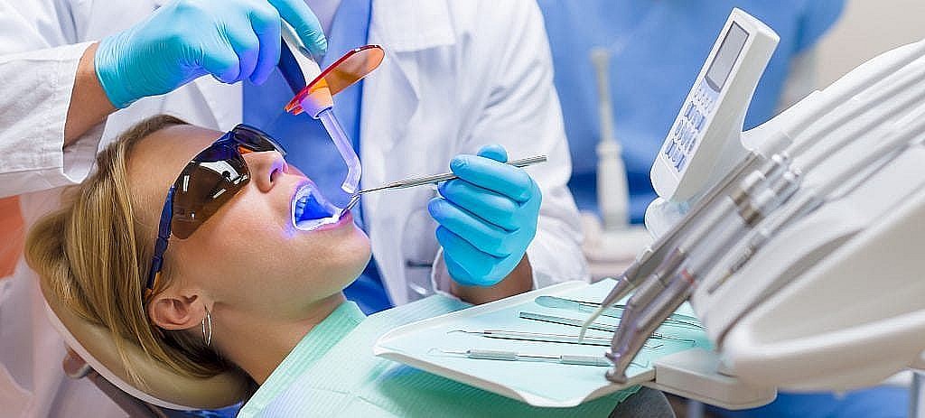 dentist performing teeth whitening