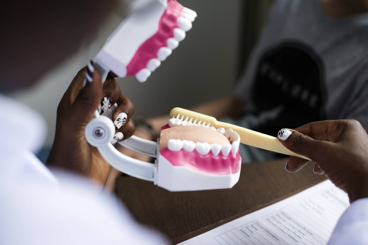 dentist with mouth and toothbrush