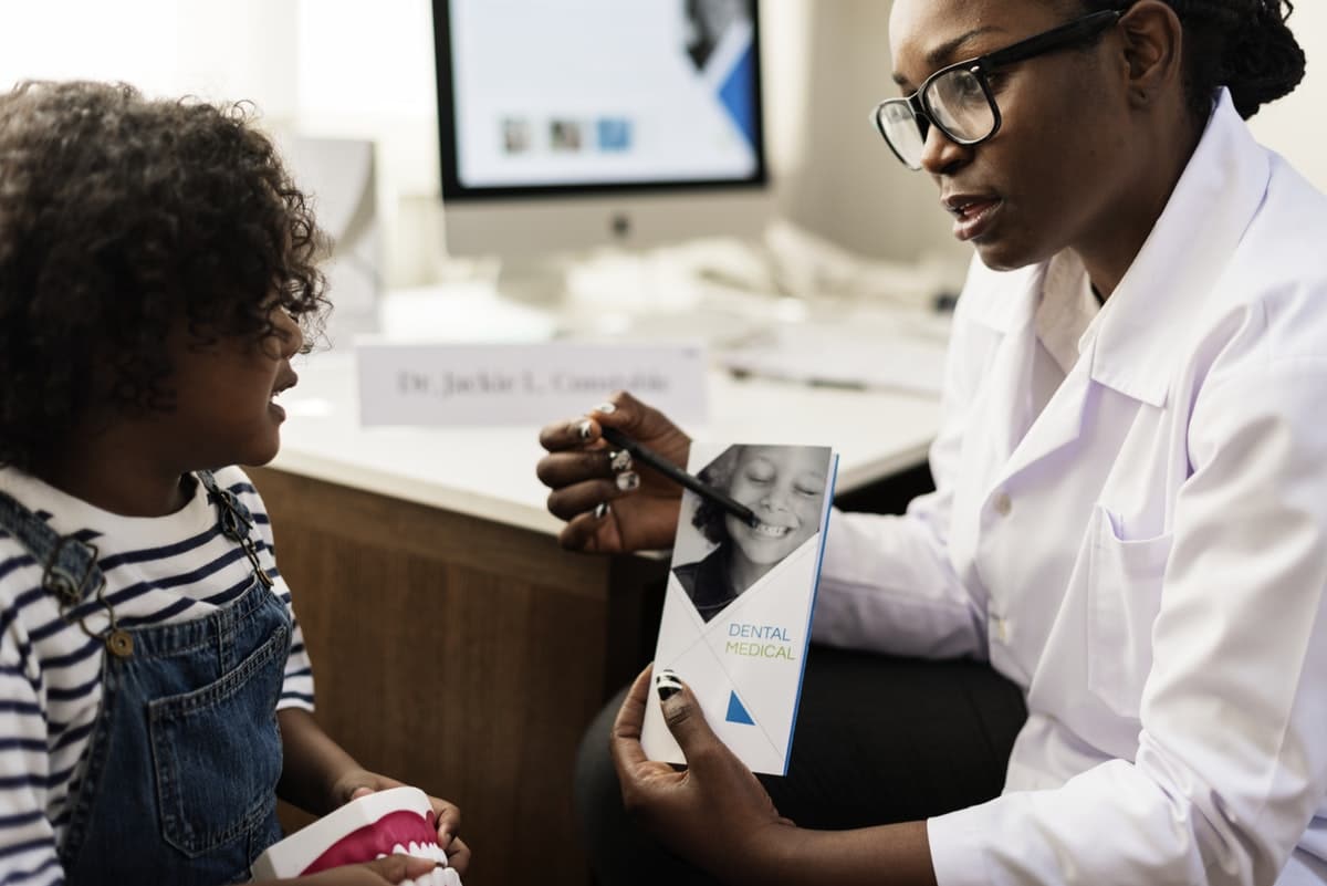 Child and dentist reading over pamphlet